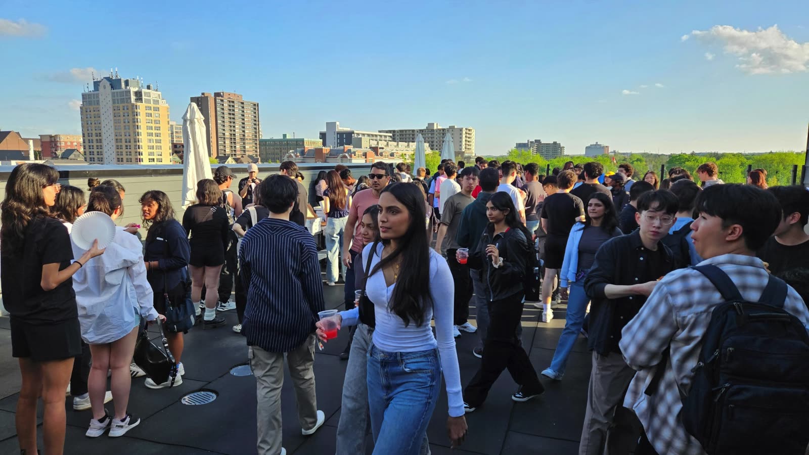 A crowd gathered on the rooftop patio at 165 King St W